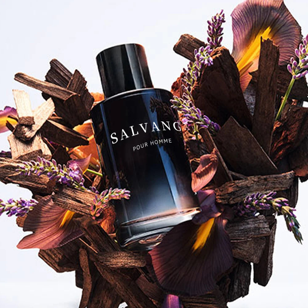 Black Salvang pour homme perfume bottle surrounded by dried flowers and wood on a white background