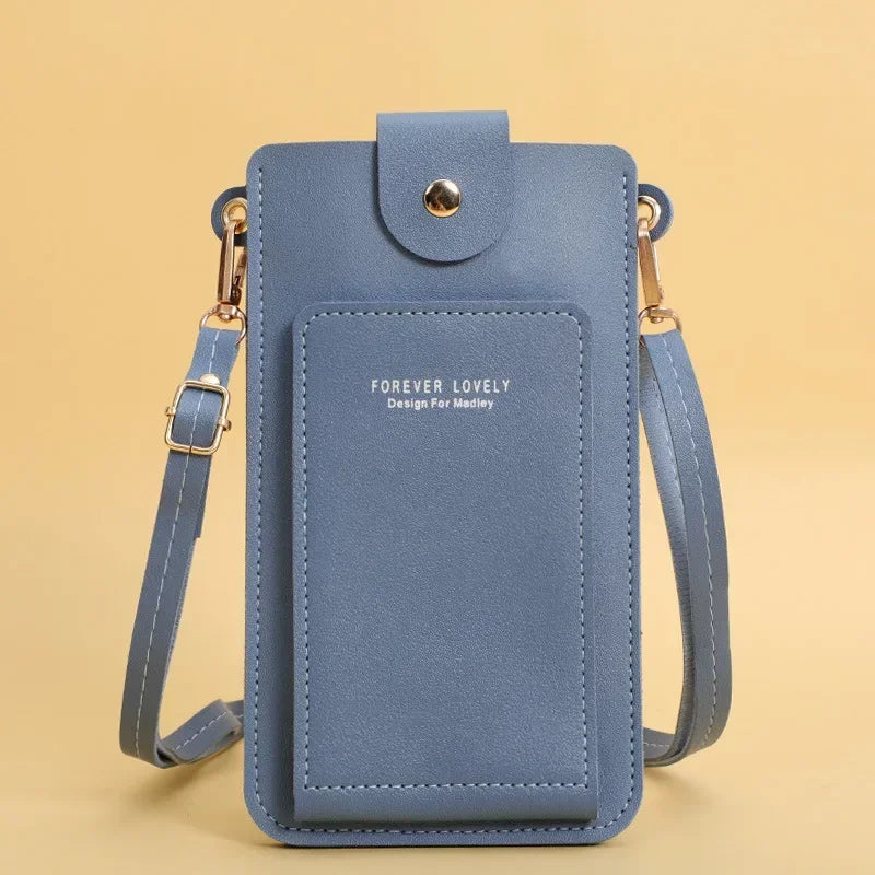 Blue crossbody bag with 'Forever Lovely' text on a beige background
