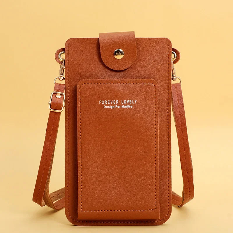 Brown leather crossbody bag with 'Forever Lovely' text on a beige background