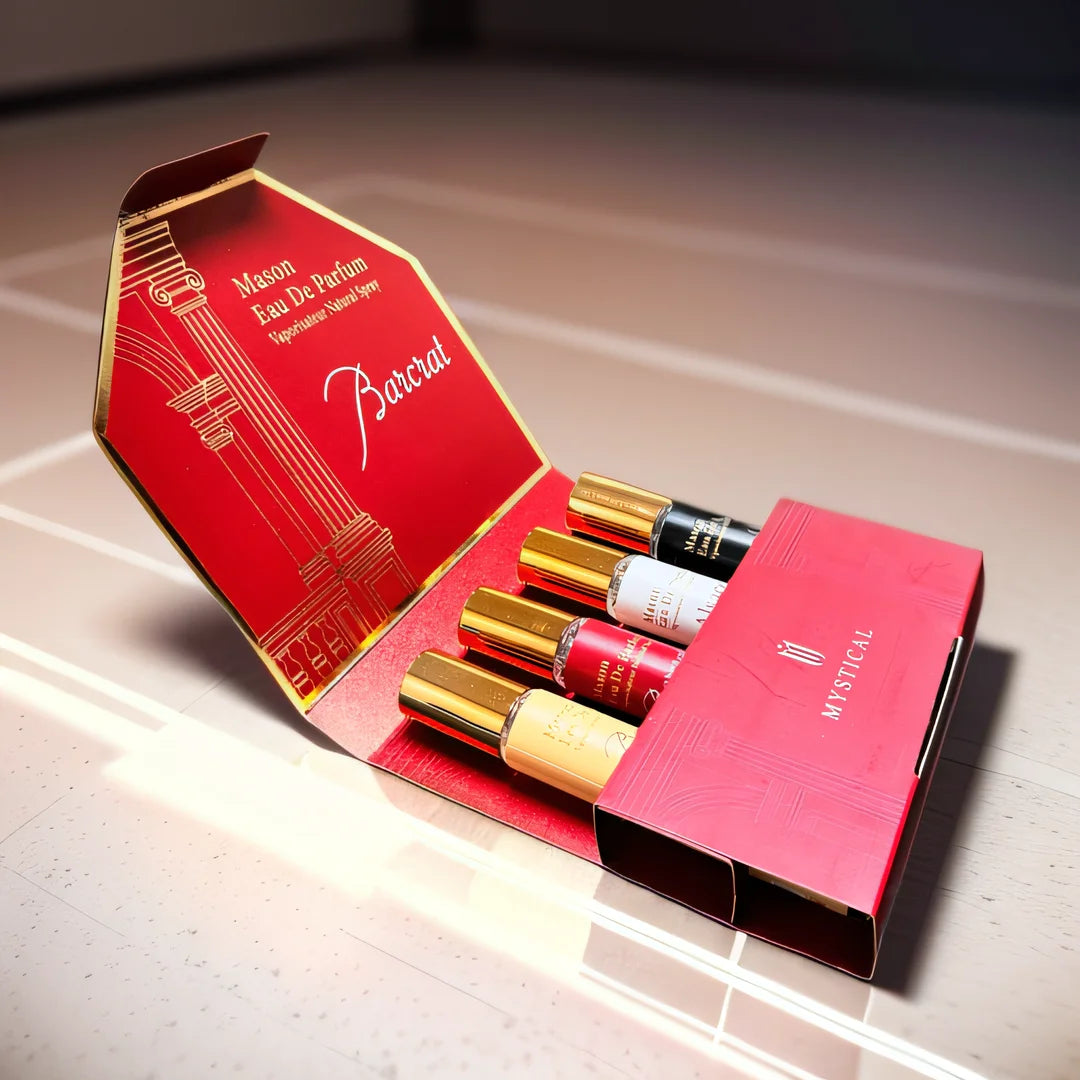 Set of miniature perfume bottles in a decorative red box on a reflective surface.